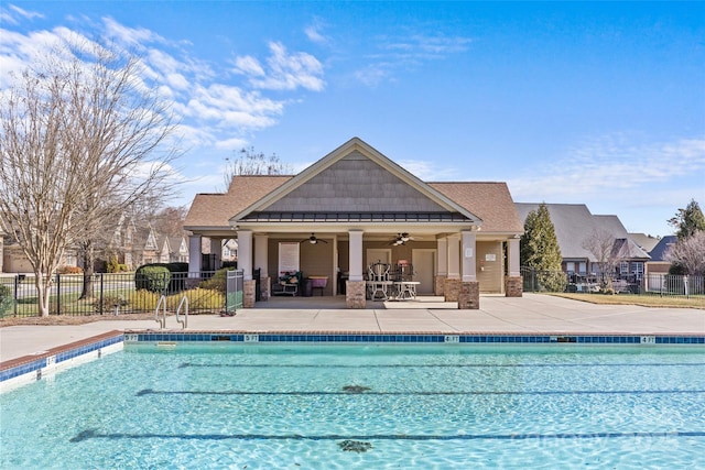 community pool with a ceiling fan, a patio area, and fence