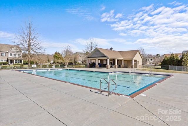 community pool featuring a patio area and fence