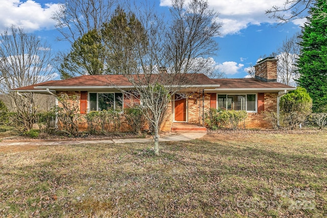 single story home with a front yard, brick siding, and a chimney