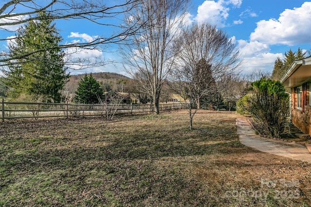 view of yard with fence and a mountain view