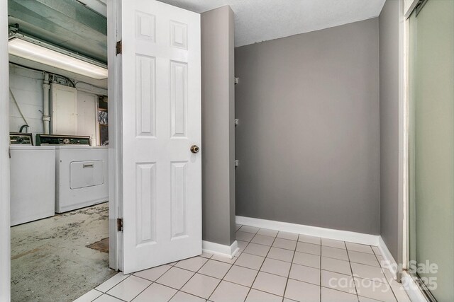 interior space featuring baseboards and independent washer and dryer