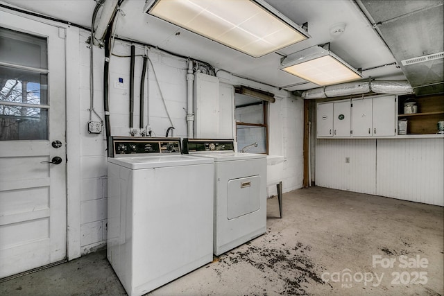 washroom featuring washer and dryer and a garage