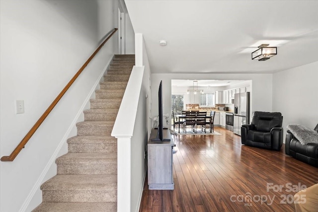 staircase with wood finished floors