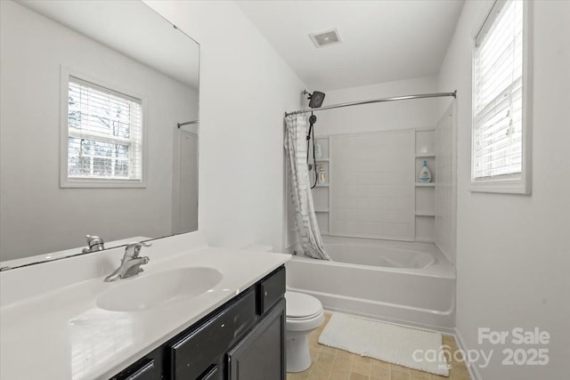 bathroom featuring toilet, vanity, visible vents, baseboards, and shower / bath combo