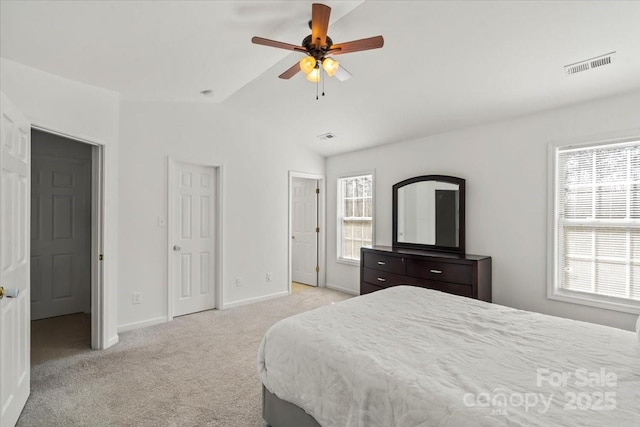 bedroom featuring light carpet, multiple windows, vaulted ceiling, and visible vents