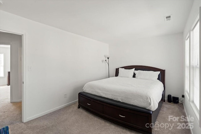 bedroom featuring visible vents, carpet, attic access, and baseboards