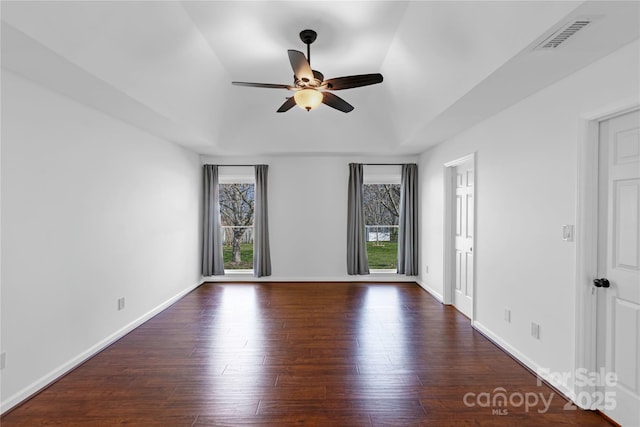 empty room with visible vents, baseboards, wood finished floors, and a ceiling fan