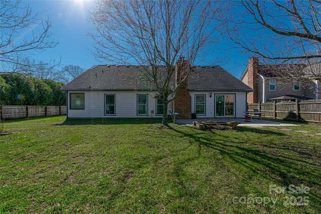 back of house with a patio, a fenced backyard, a lawn, and a chimney