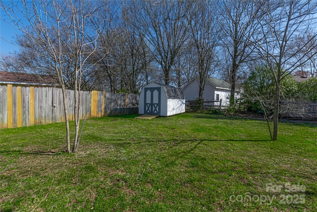 view of yard featuring an outbuilding, a fenced backyard, and a shed