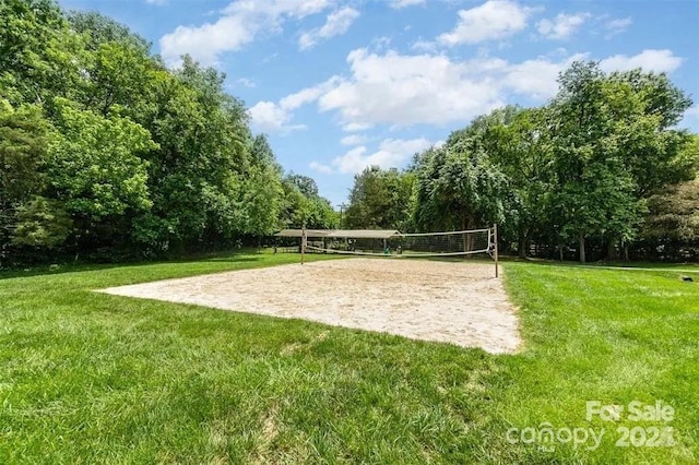 surrounding community featuring a lawn and volleyball court