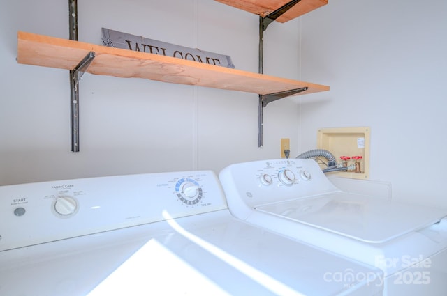 laundry room featuring a garage, washing machine and dryer, and laundry area