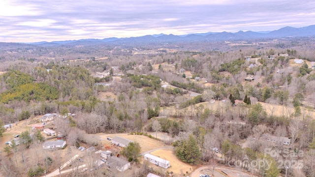 aerial view at dusk featuring a mountain view