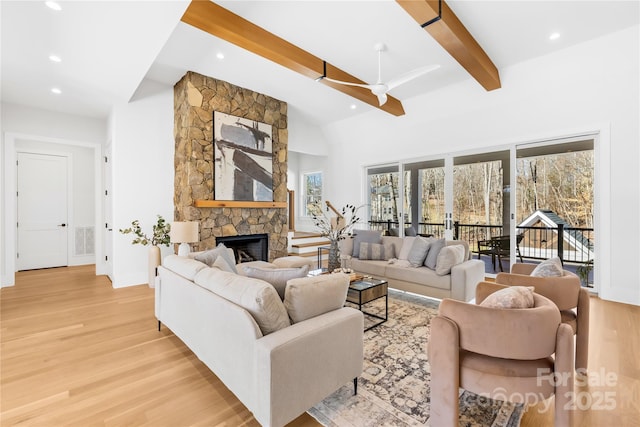 living area featuring recessed lighting, a fireplace, a ceiling fan, beam ceiling, and light wood finished floors