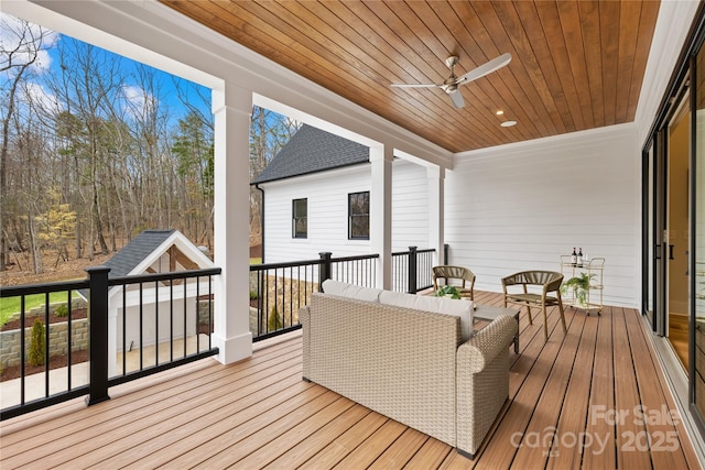 deck with an outdoor hangout area and a ceiling fan