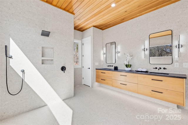 full bathroom featuring tile walls, double vanity, wood ceiling, a sink, and walk in shower