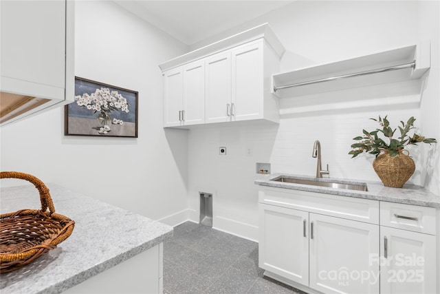 clothes washing area with hookup for an electric dryer, washer hookup, granite finish floor, a sink, and cabinet space