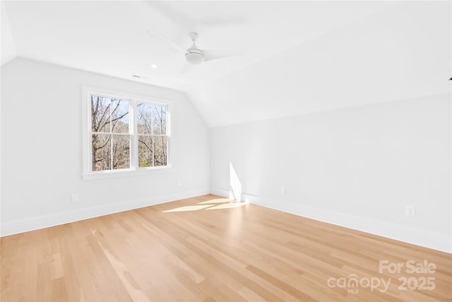 bonus room featuring lofted ceiling, baseboards, ceiling fan, and light wood finished floors