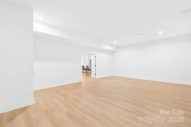 unfurnished room with recessed lighting, baseboards, and light wood finished floors