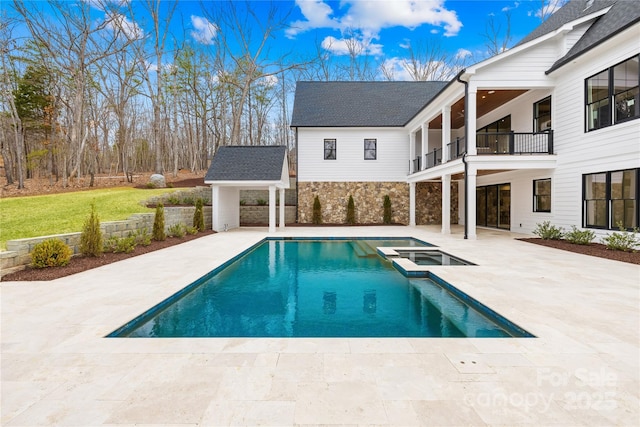 view of swimming pool with a patio area and a pool with connected hot tub