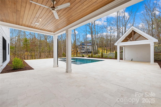 outdoor pool with ceiling fan and a patio