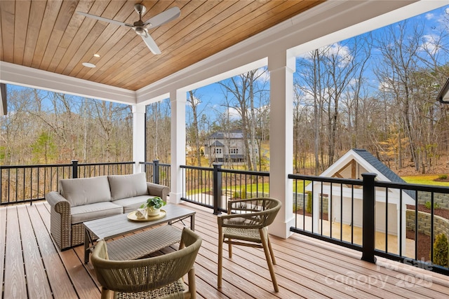 wooden terrace featuring ceiling fan and an outdoor hangout area