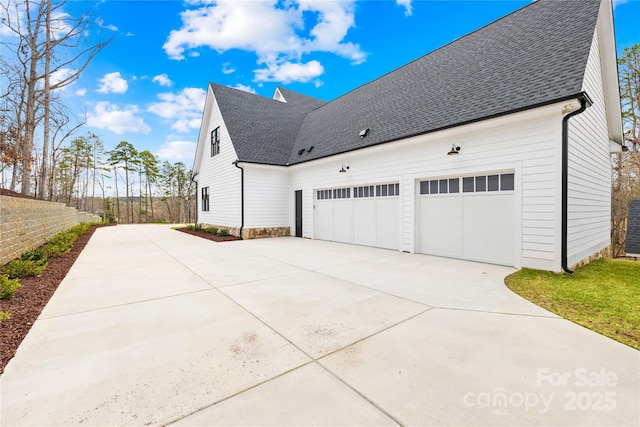 view of property exterior with a garage, driveway, a shingled roof, and fence