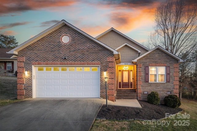 view of front of property featuring concrete driveway, an attached garage, brick siding, and crawl space