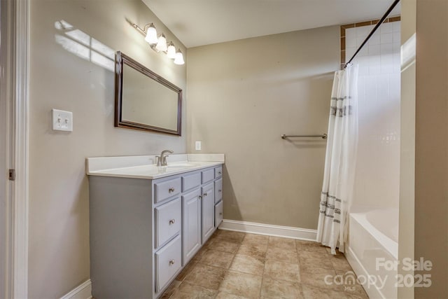 full bath featuring shower / tub combo with curtain, vanity, and baseboards