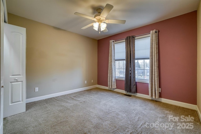 unfurnished room featuring light carpet, ceiling fan, and baseboards