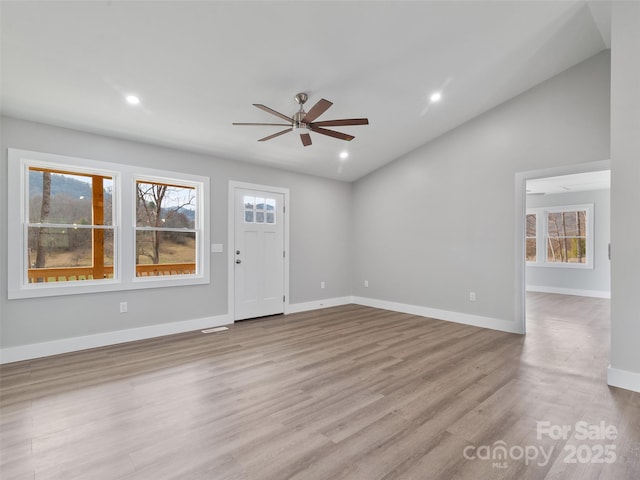 interior space featuring ceiling fan, lofted ceiling, recessed lighting, baseboards, and light wood-style floors