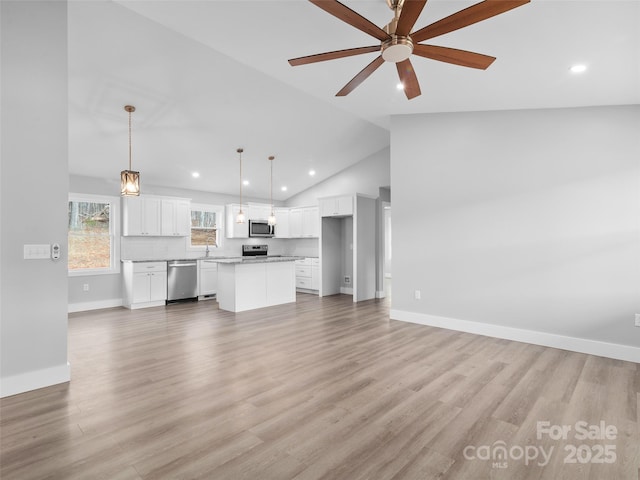 unfurnished living room with a ceiling fan, recessed lighting, baseboards, and light wood finished floors