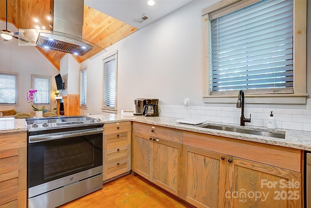 kitchen featuring light stone counters, a sink, visible vents, island exhaust hood, and stainless steel range with electric stovetop