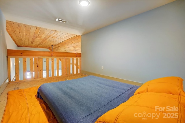 bedroom featuring wood ceiling, visible vents, vaulted ceiling, and baseboards