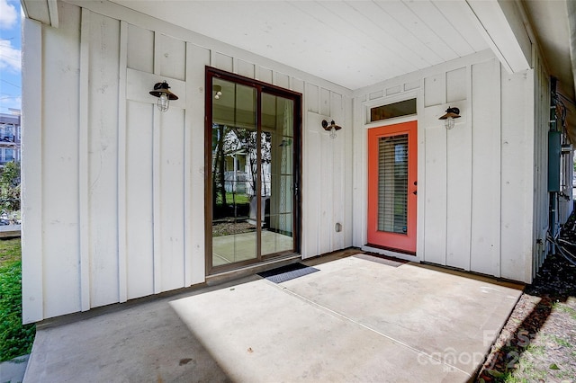 entrance to property with a patio area and board and batten siding