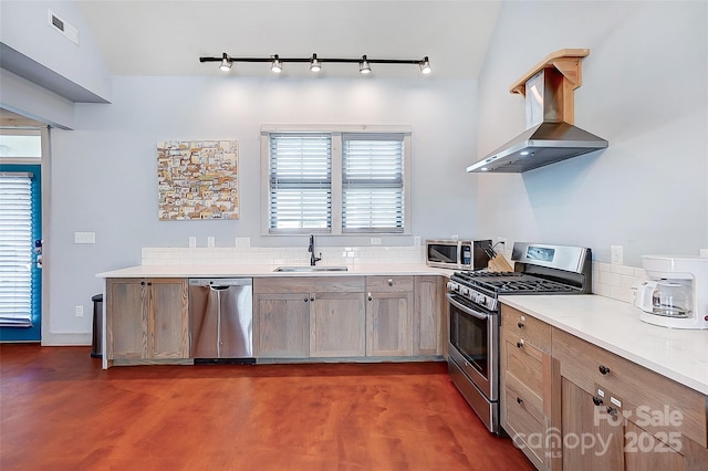 kitchen with stainless steel appliances, a sink, visible vents, light countertops, and wall chimney range hood