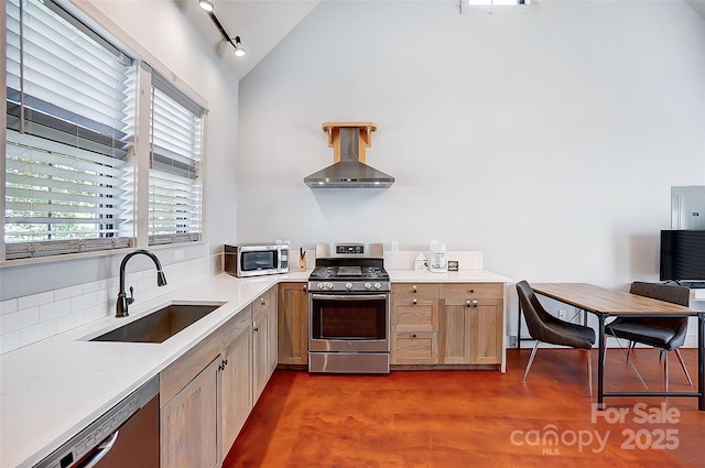 kitchen with island exhaust hood, lofted ceiling, light countertops, appliances with stainless steel finishes, and a sink