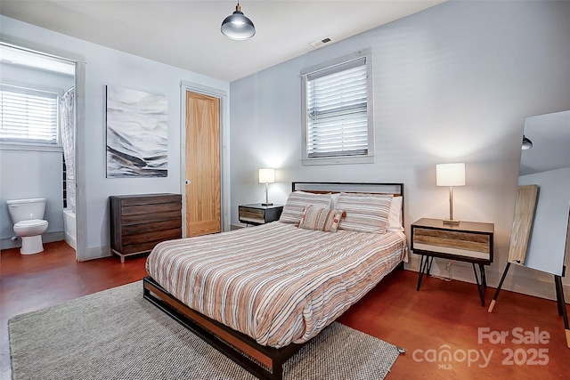 bedroom with baseboards and visible vents