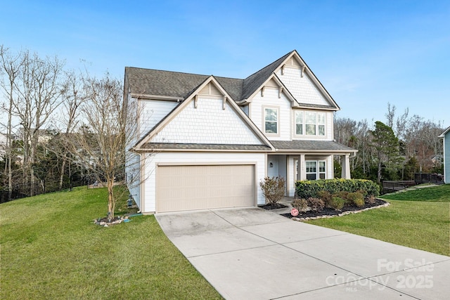 view of front of property with driveway, a front lawn, roof with shingles, and an attached garage