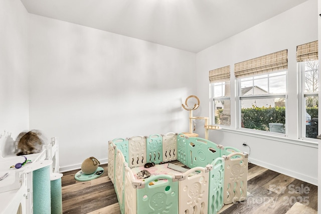 sitting room with wood finished floors and baseboards