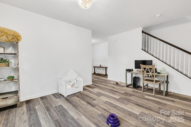 interior space featuring baseboards and wood finished floors