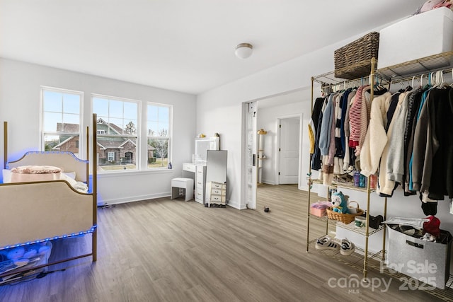 bedroom with baseboards and wood finished floors