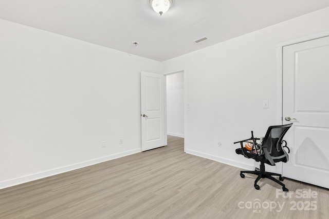 office area featuring light wood-style flooring, visible vents, and baseboards