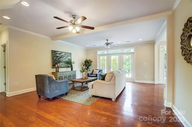 living area with crown molding, baseboards, and wood finished floors