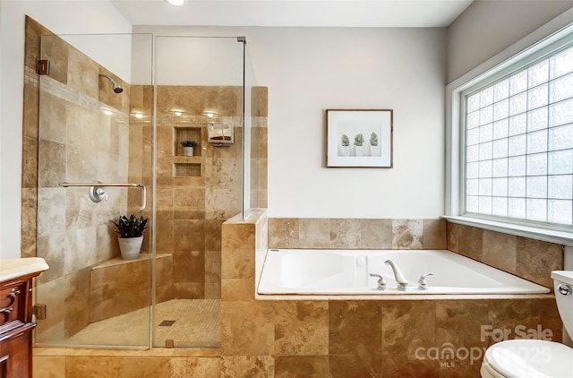 bathroom featuring toilet, a stall shower, a bath, and vanity