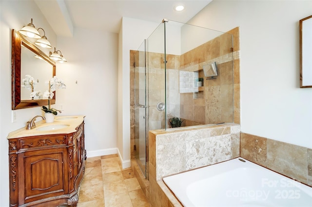 bathroom featuring a garden tub, a sink, baseboards, double vanity, and a stall shower