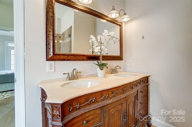 bathroom featuring double vanity, ensuite bath, and a sink