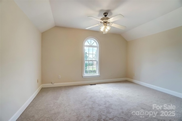 bonus room featuring light colored carpet, lofted ceiling, visible vents, and baseboards