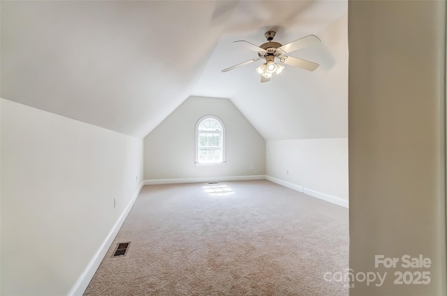 additional living space with visible vents, baseboards, a ceiling fan, lofted ceiling, and carpet