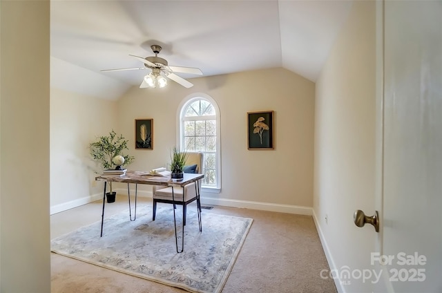 carpeted home office featuring vaulted ceiling, baseboards, and ceiling fan