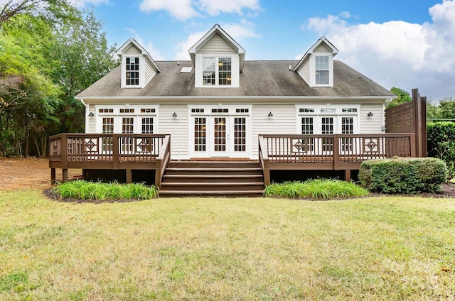 rear view of house featuring a yard, french doors, and a wooden deck